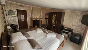 a bedroom with a large bed and a fireplace at Torre Serena B&B in Atella