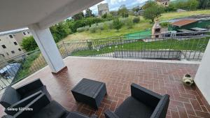 a patio with chairs and a table and a fence at Torre Serena B&B in Atella