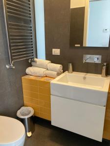 a bathroom with a white sink and a toilet at B&B Numero Uno in Bisceglie +48 photos