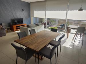 a living room with a wooden table and chairs at Grand Residence 3-Bedroom Spacious Premium Central Apartment in Is-Swieqi