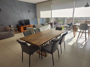 a living room with a wooden table and chairs at Grand Residence 3-Bedroom Spacious Premium Central Apartment in Is-Swieqi +9 photos