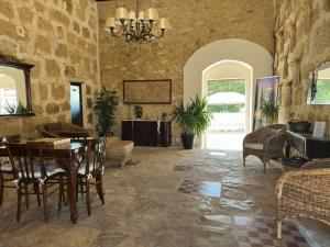 a living room with a table and chairs at Feudo Nobile in Gela