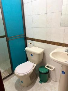 a bathroom with a toilet and a sink at Hotel Manhattan City in Duitama +15 photos