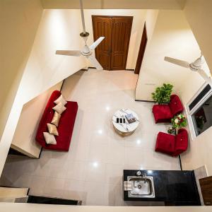 an overhead view of a living room with red furniture at Dream home 2 & 4 bedroom Family house in Karachi