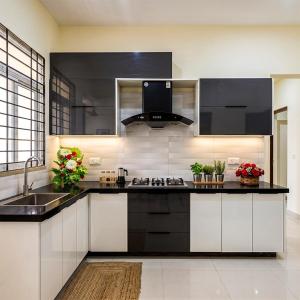 a kitchen with black and white cabinets and a sink at Dream home 2 & 4 bedroom Family house in Karachi