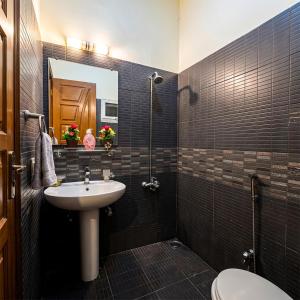 a bathroom with a sink and a toilet at Dream home 2 & 4 bedroom Family house in Karachi