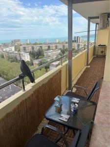 a bird sitting on a table on a balcony at Sunrise Panorama Apartment in Bŭnzareto