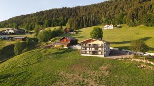 an aerial view of a house on a green hill at Hinterrainer Nature Apartments- New in Avelengo