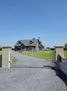 a fence in front of a house at The Front Room in Wexford