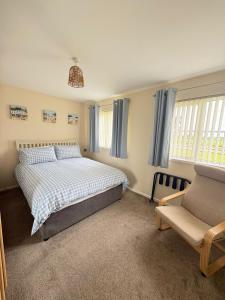 a bedroom with a bed and a couch at Rose Cottage in Portadown
