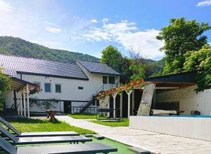 a house with a patio and a swimming pool at Pam Dubova Holiday in Dubova