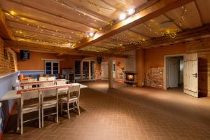 a dining room with tables and chairs and a fireplace at Vasekoja Holiday Complex in Möldri
