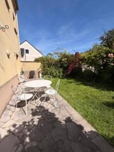 a table and chairs on a patio with a yard at Magnolia58 in Pontault-Combault +6 photos