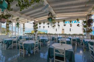 a banquet hall with tables and chairs with a view at Hotel Garden in Vlorë