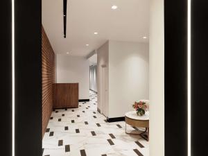 ein Flur mit Fliesenboden und einem Tisch in der Unterkunft The Clarence Hotel Sydney in Sydney