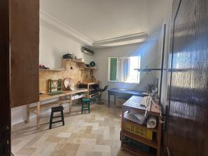 a room with a desk and a table and a tableablish at Atelier Meso in Le Kram