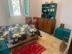 a bedroom with a bed and a book shelf at Atelier Meso in Le Kram