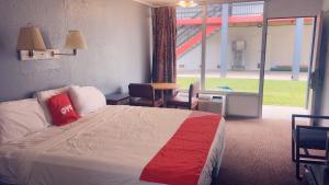 a hotel room with a bed and a large window at SPRINGWOOD HOTEL, Opelika I-85 Columbus Pkwy in Opelika