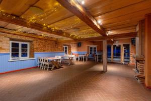 a patio with a table and chairs in a building at Vasekoja Historical House near Setomaa in Möldri +8 photos