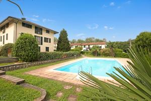 a swimming pool in front of a house at Angera Relax & Pool - Lake Maggiore Retreat - Happy Rentals in Angera