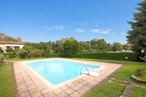 a swimming pool in the yard of a house at Angera Relax & Pool - Lake Maggiore Retreat - Happy Rentals in Angera +20 photos