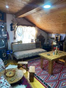 a living room with a couch and a table at Blero Rooms Rent in Pogradec