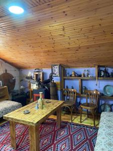 a living room with a wooden table and chairs at Blero Rooms Rent in Pogradec