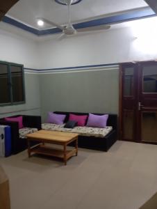 a living room with a couch and a coffee table at Unique in Ouagadougou