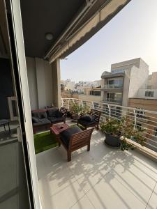 a balcony with a table and chairs on a roof at Grand Residence 3-Bedroom Spacious Premium Central Apartment in Is-Swieqi