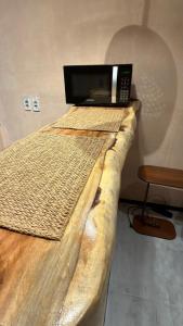 a microwave sitting on top of a bed in a room at Guajiru Beach House KiteSurf in Trairi +19 photos
