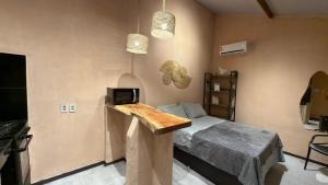 a bedroom with a bed and a tv on a wall at Guajiru Beach House KiteSurf in Trairi