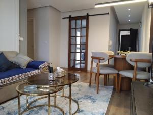 a living room with a couch and a table at Dar Residence - Madinaty B12 - U2 - 2 BR - New Cairo in Madinaty