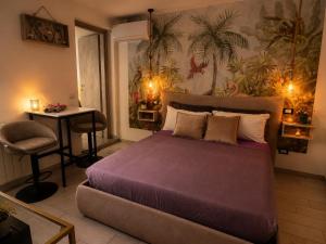 a bedroom with a bed and a table and a desk at Umbertos Rooms in Jerzu