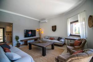 a living room with couches and a coffee table at Villa Stone Bodrum - Private Pool & Garden in Bodrum City