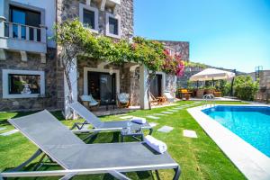a villa with a swimming pool and a house at Villa Stone Bodrum - Private Pool & Garden in Bodrum City