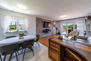 a living room with a couch and a table at Apartments Bajcic in Rab