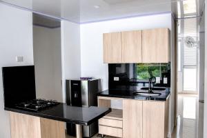 a kitchen with a sink and a black counter top at Luxury Suite with Pool in Melgar in Melgar