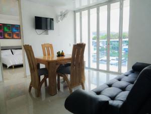 a living room with a table and chairs and a couch at Luxury Suite with Pool in Melgar in Melgar