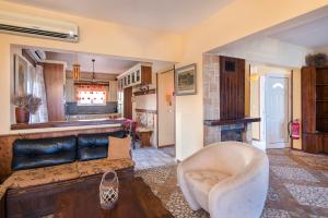 a living room with a couch and a fireplace at Alkyoni Villa in Lachania