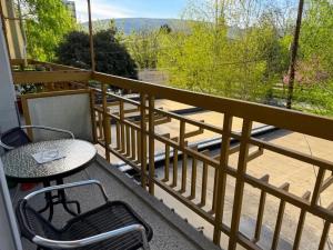 a balcony with a table and chairs on a balcony at Angel's Residence in Veles
