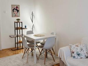 a white table and chairs in a room with a bed at Angel's Residence in Veles +5 photos
