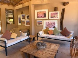 a living room with couches and a coffee table at Hotel Tulor in San Pedro de Atacama