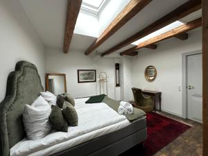 a bedroom with a bed in a room with a skylight at Liselund Ny Slot Hotel in Borre