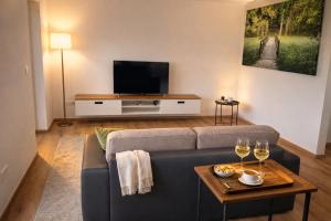 a living room with a couch and a tv at Romantic Sunset Retread I 4 Min to A2 I E-Bikes I Near Ljubljana in Velika Loka