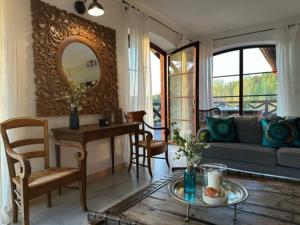 a living room with a table and a couch at Zakątek Sary in Jonkowo