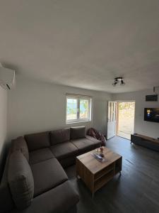 a living room with a couch and a coffee table at Lake Apartment Krupac in Nikšić