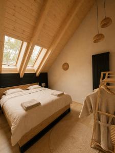 a bedroom with a large bed and a window at Cabana Crang in Dobra