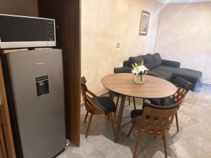 a living room with a table and a refrigerator at Loft Elena en ValQuirico in Santeagueda