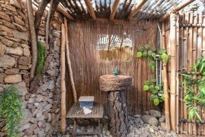 a bathroom with a sink and a stone wall at El Refugio de Las Vegas in Valsequillo