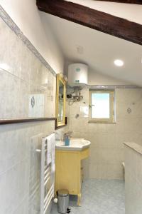 a bathroom with a sink and a mirror at Balcone sul Vesuvio in Vico Equense